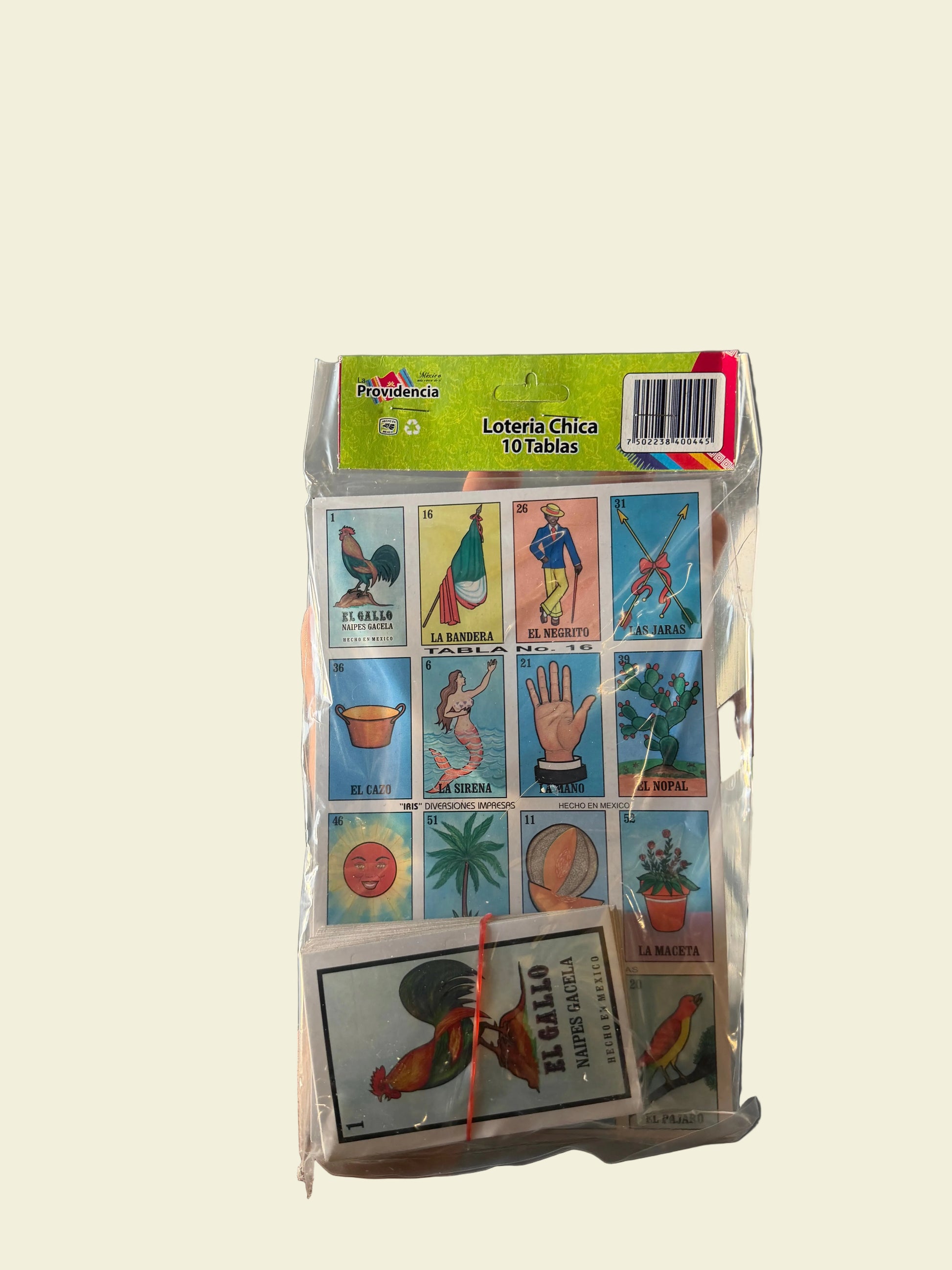 Collection of vintage-style playing cards in a transparent plastic holder on a gray surface.
