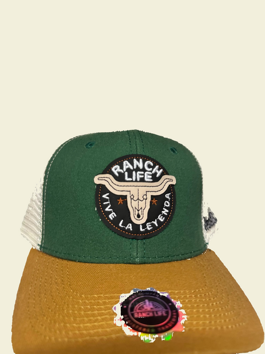 Green and brown cap with 'Ranch Life' logo on a white surface with cardboard box in the background